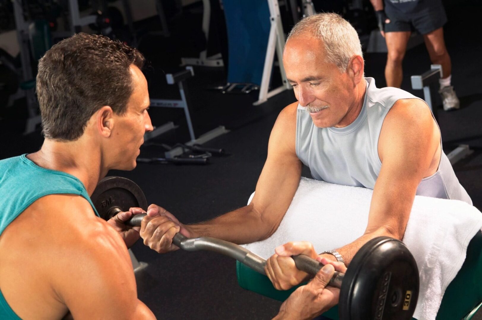 Two men are talking to each other in a gym.